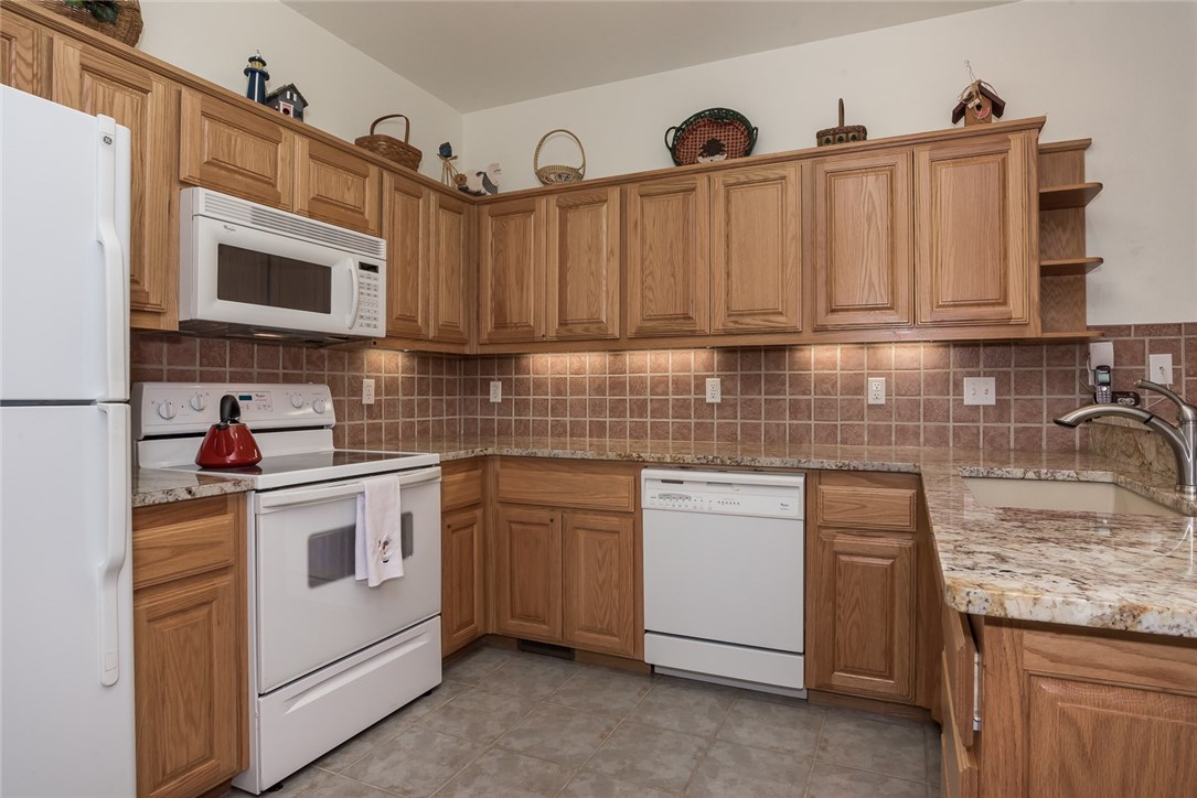 This lovely 3 bed, 2 bath home offers open concept living/dining/kitchen with split bedroom plan. Includes all appliances, kitchen has a solar tube & new granite counter tops, pantry in laundry area. Inviting sun room w/lots of windows & access to deck & back yard. Maintenance free exterior w/new 35 year roof, easy access to club house as well as golfing and to the main highway. This one owner home has been lovingly cared for & sellers were here only 6 months out of the year.