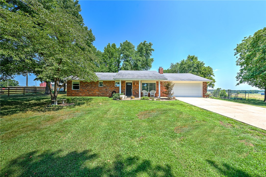 Drive up to 16802 Bayberry, PG & youāll find 7.63 acres of complete seclusion, with large farms surrounding. Wood panel fence runs the front driveway. Property is fenced & crossed fenced. Great place for a small farm, horses, few cattle, and a chicken coop 16x14 custom built in 2020. Well maintained, brick home offers 3BR & 2 Baths with a wood burning fireplace. Updates include new LVP, granite, painted, HWH. Enjoy the privacy & scenery from your covered front & back porches. Property includes metal shop/pole barn 50x50 with 10x10 tack room, Barn 20x50, well house & outbuildings. And letās not forget about the lit-horse-riding arena.