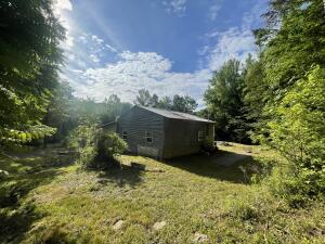 Hunters paradise for the outdoor enthusiast. Close to the National Forest is this 2 bedroom 1 bathroom cabin style home on 1.55 acres. With a small creek running through property and additional land on opposite side of the river, build a second cabin retreat. Home features a large living room with freestanding stove, and large kitchen. Also included is an attached greenhouse sunroom. Land gently slopes and has an additional outbuilding barn on property. Perfect getaway in the Ozark National forest. House sells as is, no repairs, no termite, no home warranty. Survey complete. Utilities include city water, septic, and Wave Rural Internet installed. Home is all electric, no gas. Located in a secluded rural area with abundant wildlife and outdoor activities.