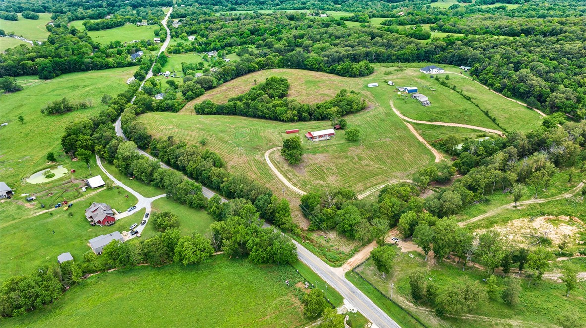 Imagine a life where wide-open skies meet endless possibilities. This unique property sits on 23 scenic acres and offers some of the best sunsets in Northwest Arkansas. The thoughtfully designed home is ideal for extended family living, with flexible options to function as a single residence or be easily separated into a duplex or multi-unit layout. Whether you're looking for multigenerational space, income potential, or bothāthis setup delivers. Attached to the back side of the home you'll find barn stalls and a large concrete slab perfect for parking or future expansion. Room to roam, room to grow, and room to dreamāall just minutes from Siloam Springs. Property is being sold AS-IS. Front unit needs a remodel. Back unit is move-in ready. Possible owner financing available!