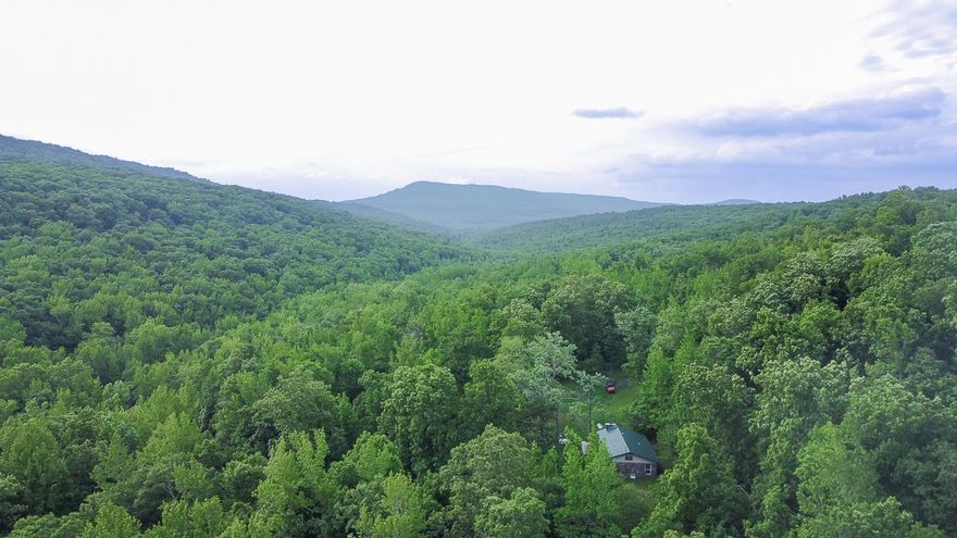 20 ACRES OF BREATHTAKING NATURAL BEAUTY
Discover your own slice of paradise with this 20-acre property, nestled deep in the serene Ozark Mountains. Tucked deep in the Ozark Mountains between Crosses and Combs, this limestone home offers privacy and natural beauty. Built in 1978 with locally sourced stone, it features a mostly Open Layout, A versatile space ready for your personal touch. and a Wood-Burning Fireplace adds warmth and character to the living area. The interior is mid-remodel—new drywall is in place, but flooring is not yet installed. The home sells as-is, offering a blank canvas for a custom retreat. Surrounded by wilderness, yet still within reach of Fayetteville and NWA, it’s the perfect blend of seclusion and access.