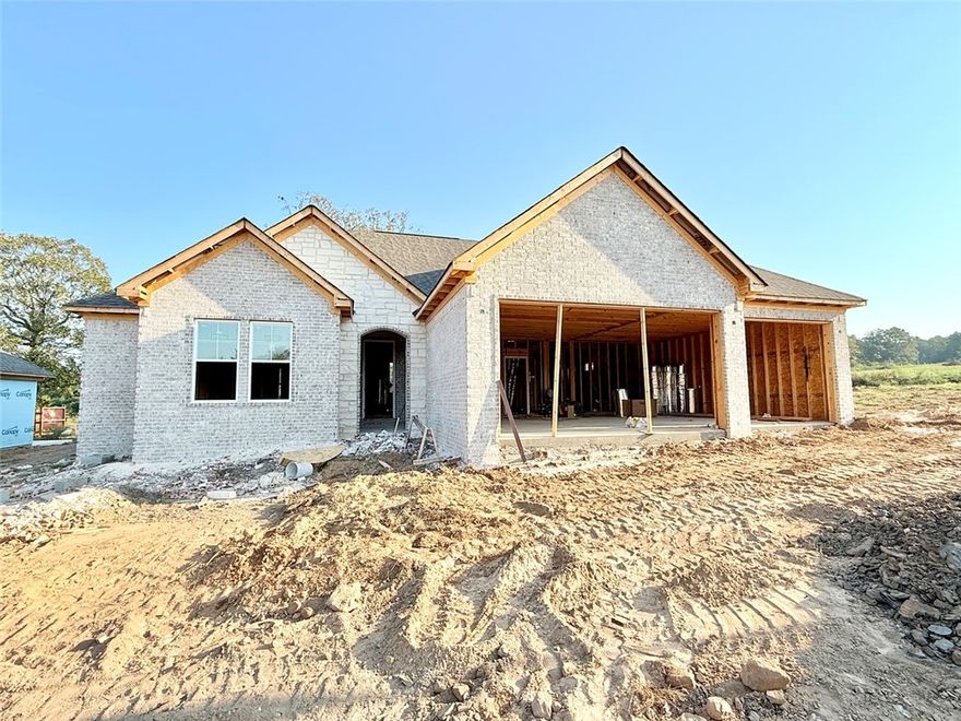 Currently under construction, photo is for information only—colors and finishes may vary.
Lot 23 on Elk Horn in Scenic Way Village offers 2,219 square feet of beautifully designed living space with 4 bedrooms, 2 bathrooms, and a 3-car garage. The home’s thoughtful layout includes a cozy living room with a fireplace, a walk-in pantry just off the kitchen, and a utility/mudroom that conveniently connects to the primary suite’s walk-in closet. Each bedroom features a walk-in closet for added functionality. Nestled near Lake Dardanelle State Park and minutes from downtown Russellville, this home combines comfort, space, and accessibility in one desirable location.
Plans are subject to change at the builder’s discretion.