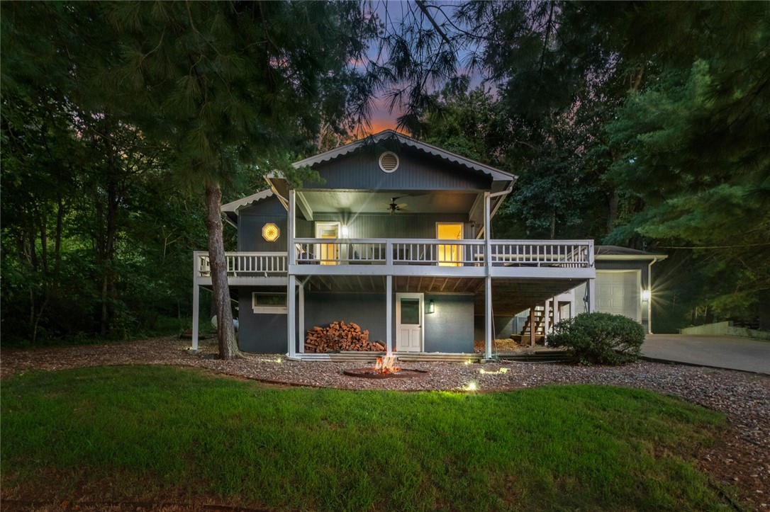 Lakefront retreat with year-round views! This 2-bedroom, 2-bath home offers a peaceful lakeside setting on a large lot. Interior features include a cozy living room with gas-log fireplace, and an updated functional kitchen. Outside, enjoy the wonderful wrap-around deck. A fantastic location just steps from Lake Ann and the Back 40 Pinion Creek Trailhead, perfect for kayaking, biking, fishing, and lakeside living in Bella Vista’s vibrant resort-style community with golf, clubs, pools, and scenic trails. The house is situated across from the boat launch for easy lake access. Property has great short term rental potential and has operated as an STR previously.