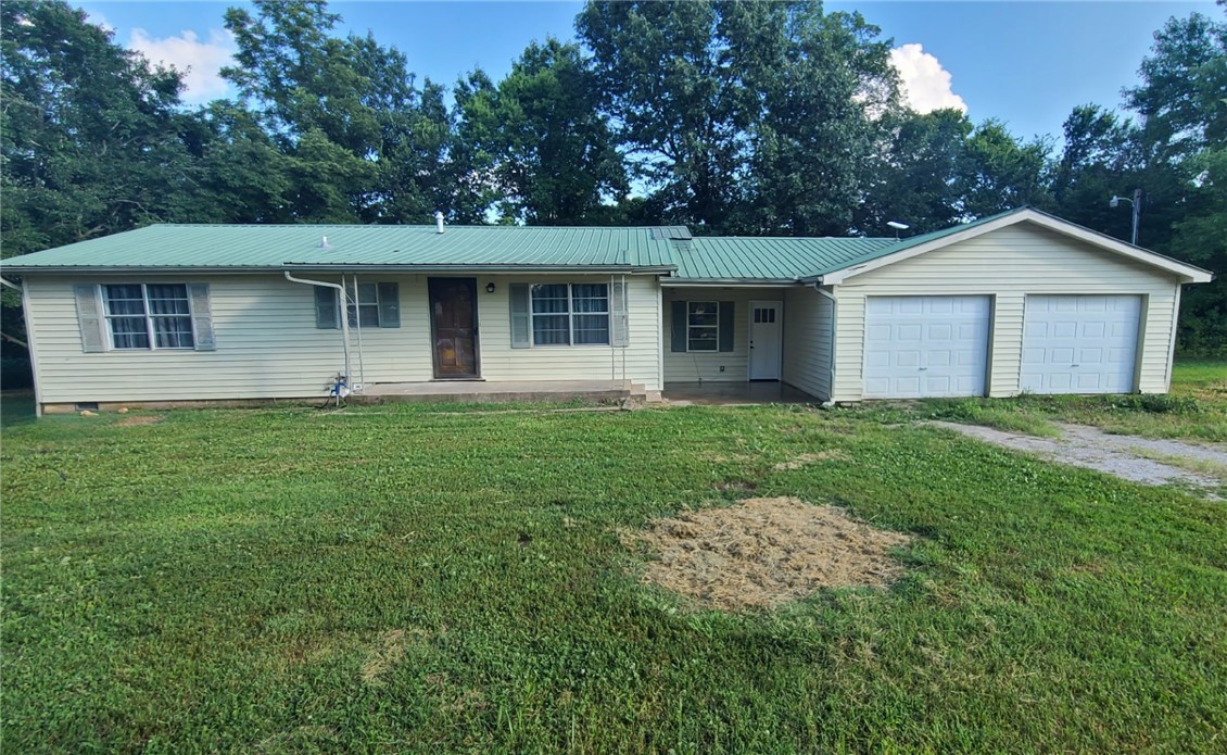 This unique almost 20 Acres is a blank canvas ready for your personal vision The house has been remodeled with updated electrical,hvac system and on demand hot water heater. The approx. 2300 sq ft workshop has an attached office with a full bathroom. This would be great for running a business.2 additional pole barns with room to have animals,equipment or storage.Land is a mix of open pasture and woods with private trails for walking or riding. A creek which is fed by 2 natural springs cover most of the property.It's all here to start living the peaceful life. Seller is offering $5,000 in concessions to purchasers. 24 hr notice to show.