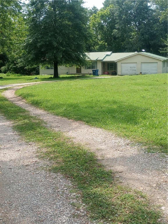 This unique almost 20 Acres is a blank canvas ready for your personal vision The house has been remodeled with updated electrical,hvac system and on demand hot water heater. The approx. 2300 sq ft workshop has an attached office with a full bathroom. This would be great for running a business.2 additional pole barns with room to have animals,equipment or storage.Land is a mix of open pasture and woods with private trails for walking or riding. A year-round creek which is fed by 2 natural springs cover most of the property.It's all here to start living the peaceful life.