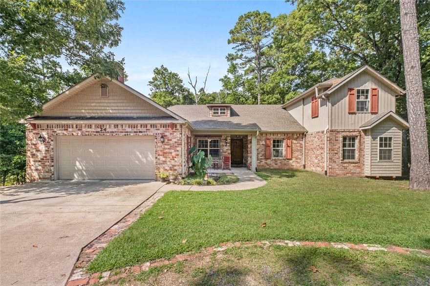 Welcome to your dream home in Bella Vista, Arkansas—where comfort meets adventure and nature blends seamlessly with daily living. This expansive 4-bedroom, 3-bathroom residence offers over 4,198 sq ft of beautifully designed space across three thoughtfully planned levels, perfect for large families, multi-generational living, or those who love to entertain. Nestled on two peaceful lots totaling 0.53 acres, the home offers privacy and serenity, surrounded by mature trees and natural beauty. Enjoy your morning coffee or host gatherings on the multi-level deck. Inside, you’ll find inviting living areas with fireplaces, a spacious kitchen with custom cabinetry, and multiple seating zones that flow into formal and casual dining spaces. The bedrooms are generously sized, and the primary suite is a tranquil retreat with views of the woods. Just 0.5 miles from the Buckingham Trailhead, part of the Back 40 and OZ Trails, enjoy world-class biking and hiking right outside your door.