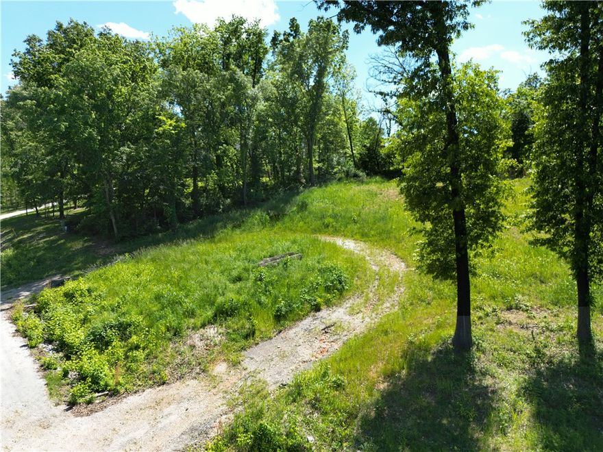Rare opportunity to own just over 3 acres in a gated rural subdivision, priced well below comparable properties. This wooded tract offers the perfect balance of privacy and readiness, with a cleared homesite and established circle driveway already in place. Utilities are a major plus—electricity and water are on-site, saving time and upfront costs. The property has been perc tested for a 5-bedroom home, with results available, making it ready for your custom build (septic required). Enjoy a secluded setting while still benefiting from convenient access to the new bypass connecting Highway 412 and 612, providing an easy commute to nearby amenities. Don’t miss your chance to secure land with this level of preparation and value!