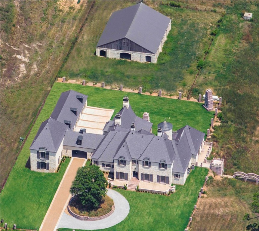 English Countryside Estate with private entry, cobblestone drive, 4,900 SF barn with 6 horse stall and pond. Slate roof & beautiful Austin Stone exterior. Extensive millwork featuring 23 exotic wood species. Free standing spiral staircase, indoor 100 yd. shooting range, Safe Room w/bank vault door, wine room & media room. Schonbeck Venetian Crystal chandelier light fixtures. Smart Home Technology for thermal, motion, lighting, sound surveillance. 6,000 SF metal workshop. Could have 4+ add bedrooms.