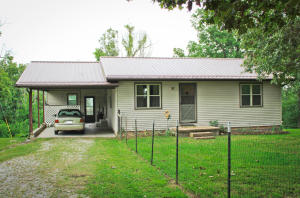 Very cute and well cared for 2 bedroom 1 bath home with a country setting on a paved road. This home features laminate floors throughout, a large deck great for entertaining or sitting and looking at the beautiful view along with many updates since 2013 that include the heat pump, metal roof, double hung windows, water heater, insulation, garage siding, garage door opener and deck along with deck lighting. There is tons of storage and extra room in the basement that is heated and cooled and also houses the washer and dryer.