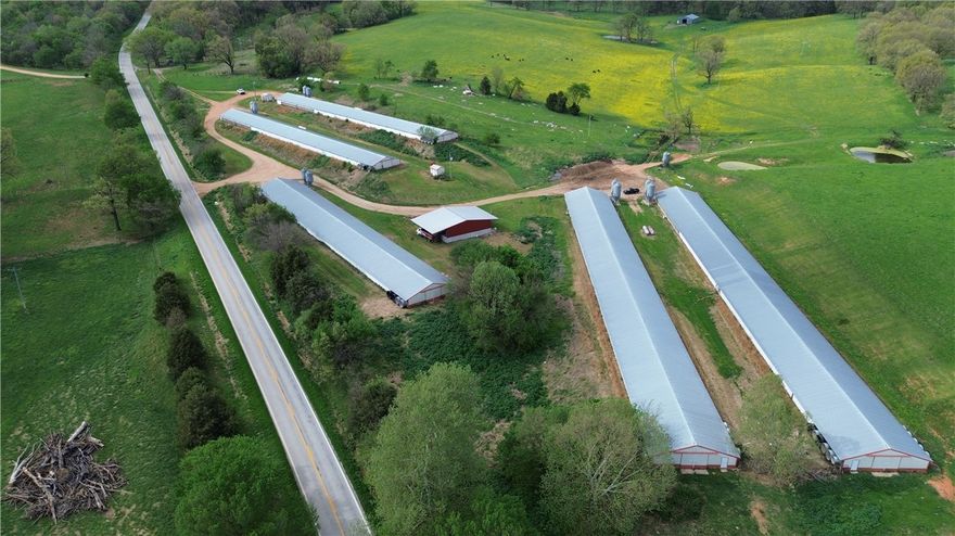 This 5-house poultry farm on 14 acres has an active Tyson contract, income producing and is ready for its next owner. All 5 houses have new heaters, several new fans, and all new exhaust fans. Houses 1 and 2 have newer feed lines. The property includes 3 wells with new pressure tanks, a concrete water holding tank, and a 40x60 stacking shed with compost boxes. Each house has its own owned 1,000-gallon propane tank. The 2 bed, 2 bath, 1,724 sq ft residential home on the property is an added bonus for you or hired help. (Home is being sold “AS-IS”)  A solid operation —don’t let this one pass you by!