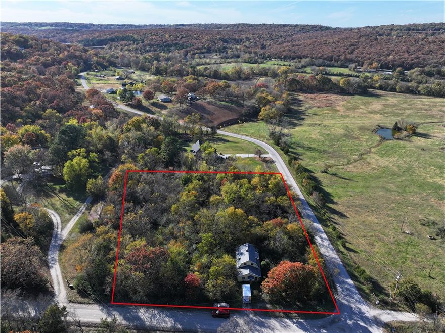 Discover the potential of this 2-acre property — a true blank canvas ready for your vision. Utilities are already on site, making it easy to bring your dream home to life. The existing older home and shed hold no value; the true opportunity lies in the land itself. Located just 2 miles off Highway 62 and only 1 mile from beautiful Lake Prairie Grove, this property offers both convenience and tranquility.  Road frontage on both Prairie Grove Lake Road and Rocky Hill Road.  Don’t miss this chance to create your ideal retreat in a peaceful setting.