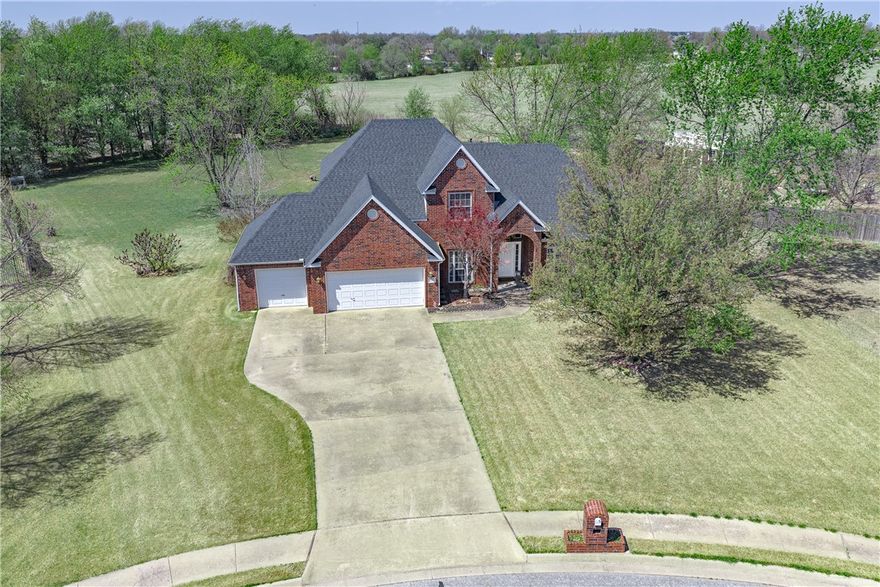 Welcome to 505 Elk Dr in Elm Springs — a beautifully maintained 4-bedroom, 2.5-bath traditional home nestled on 1.11 acres in the quiet, established Oak Ridge Estates. With 2,875 sq ft of thoughtfully designed living space, this home features the primary suite and a private office on the main level, while three additional bedrooms and a full bath round out the upper floor. The stunning double-sided fireplace connects the kitchen and family room, creating a warm, inviting heart of the home. Brand new kitchen appliances, a new roof and gutters, and a new 5-ton HVAC mean the big-ticket items are already done. A 3-car garage, granite counters, wet bar, and generous storage complete the package. Situated on a cul-de-sac with one of the largest lots in the neighborhood, you're just minutes from Lake Elmdale and I-49. This one checks every box — space, updates, location, and value at $650,000.