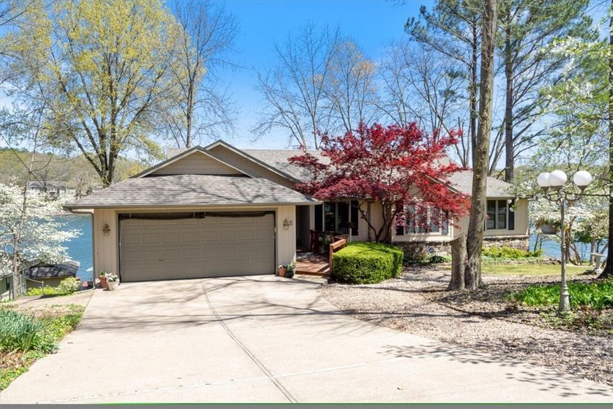 One of the most spectacular locations on Loch Lomond! You could search for years and not find a better spot for a lake home in Bella Vista.With a gentle slope to the water, to the endless views, this home is situated on more than a half acre with over 300' of lakefront. Not to mention not one, but two covered boat docks! The Living Room on the Main Level has a beautiful stone wood burning fireplace that is a beautiful centerpiece. Behind it is a spectacular Sunroom with the best views possible! Two Bedrooms and two Bathrooms on the main level. Plus a remodeled Kitchen and large Utility Room with sink. The Lower Level features another Bedroom and Bath, and a large Living Room with a wood stove. There's another 450 square feet of heated and cooled space that could easily be finished for whatever you need. The Lower Level also has a mini-bar and perfect room for a wine cellar. And there's plenty of storage! The driveway is not steep and the home sits on a quiet cut-de-sac. Location...location...location! Come on home!