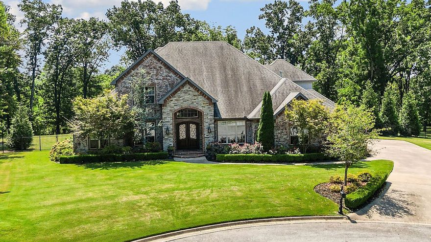 This stunning home in the Versailles neighborhood is a blend of sophistication and resort-style living.  The exquisite architectural details, soaring ceilings, and masterfully curated interiors set this home apart. Truly, a private paradise with heated pool & adjoining pavilion.Well-equipped outdoor kitchen, airy outdoor living area, plus fireplace & full bath make this a true entertainment utopia. Inside,the updated primary suite features a spa-like bathroom with soaker tub,oversized shower,walk-in closet,& a seamlessly integrated safe room .The kitchen is a culinary delight with ceiling height cabinets and a huge island.Adjacent is an inviting keeping room, full of natural light & anchored by a fireplace & cathedral ceilings.Other highlights include a stunning living room with soaring ceilings, an elegant dining room, first floor guest suite, & gentleman's office. Upstairs are 2 bedroom ensuites, 2 bonus rooms, & half bath. Craftsmanship & extensive custom features make this home is the epitome of luxury living.