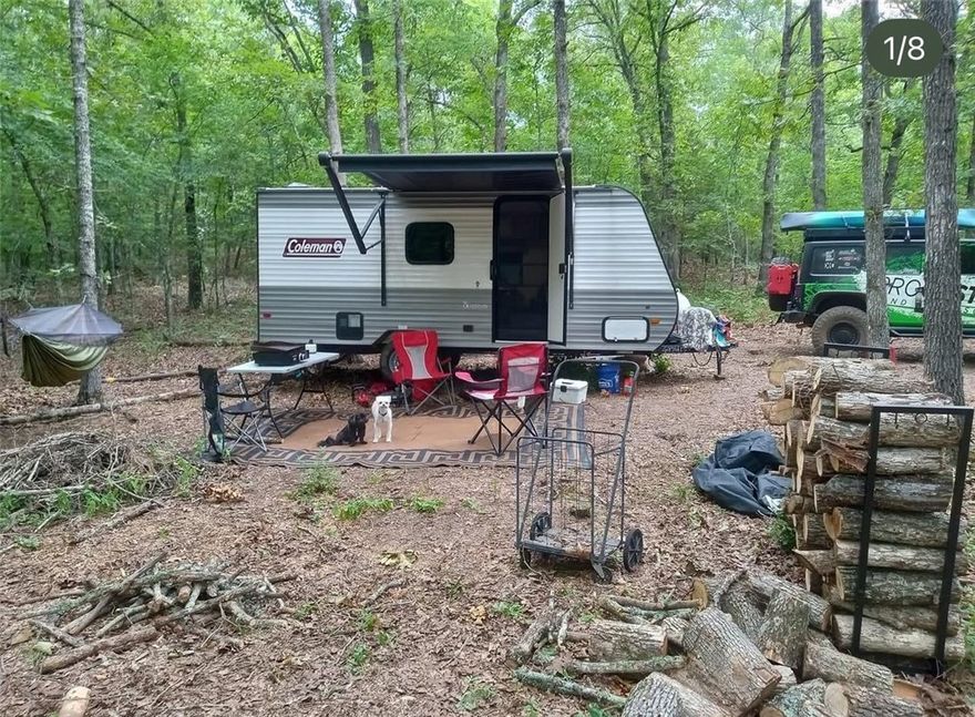 Secluded 5-acre retreat in the heart of Newton County! This all-wooded property offers the perfect setting for your off-grid cabin or weekend getaway, with stunning views overlooking the Little Buffalo River Valley. A 2023 Coleman Lantern 17B camper is already on site, along with a Predator 5000 generator, storage shed, and a 250-gallon propane tank installed by Scott’s Propane—giving you a ready-to-enjoy setup from day one. Wildcat Hollow drainage winds through the property, featuring beautiful cascading waterfalls when there's water. The large cleared area provides an ideal spot for camping, gatherings, or building your dream cabin. If you’ve been searching for a peaceful escape surrounded by nature, this property is it.
