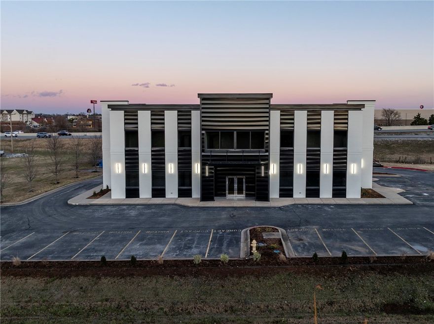 Premier office space in a prime location centrally positioned between Bentonville and Rogers. Notably one of the most visible properties available on I-49 in Benton County. Complete exterior renovation in 2025. This 2 story Class A office was previously used as a real estate office. Currently has open reception with elevator and 2 conference rooms, 35 private offices, large training room with drop down projection, central audio system, large kitchen breakroom area and private restrooms on both floors. Owner offering $150,000 TIA with a 10+ year NNN lease. 2-5 minutes from Sam’s Home Office and Walmart Campus. Easy access to both 71B and I-49. Marketed for sale MLS 1339395.