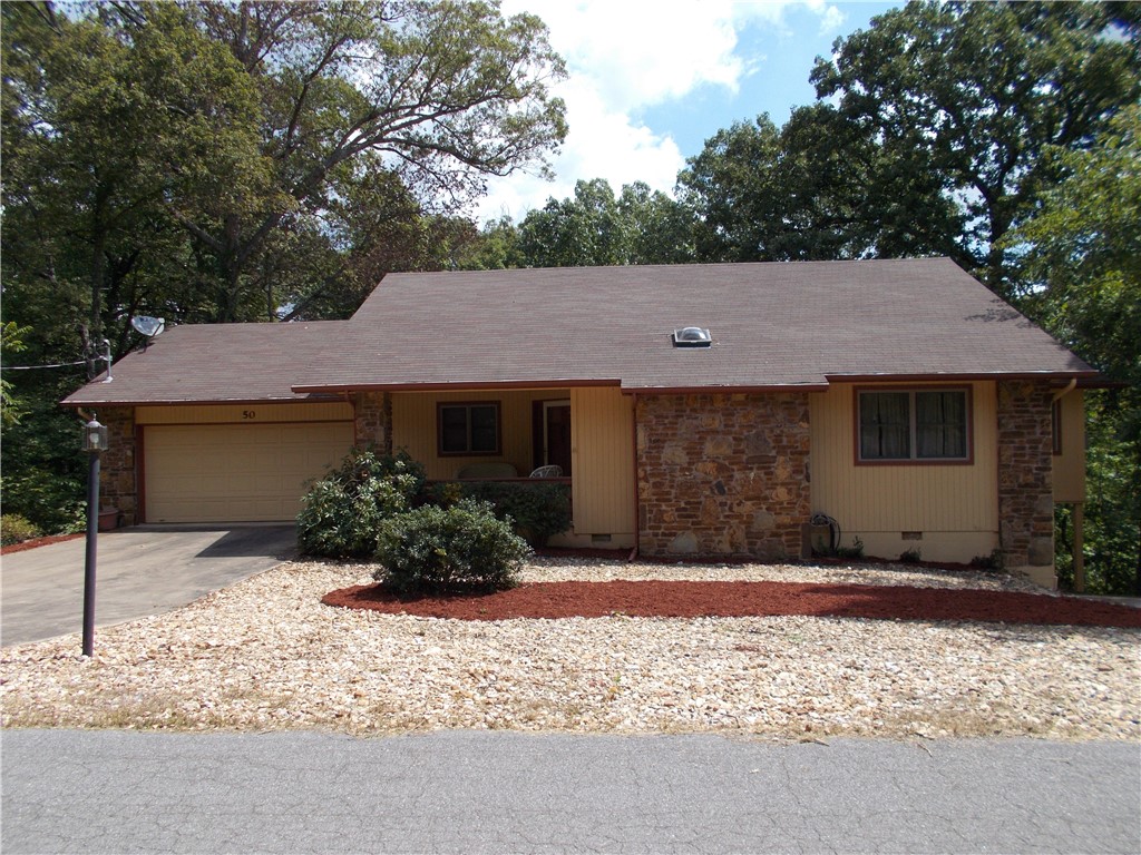 Super location! Move in ready! Quite neighborhood just minutes from Bentonville. Very unique floor plan, 2 large bedrooms 2 full baths with an updated kitchen on the main level. (1356 SQ FT ) Kitchen has Granite countertops with all appliances including Washer & Dryer! Main level also features a bonus/sunroom and a large deck overlooking a level backyard and mature trees. Downstairs ( 520 SQ FT) has another large bonus room with a full bath and a closet/storage room. A sliding door opens up to a nice porch and level backyard. Landscaped level front yard with an oversized 2 car garage on one side of the home and a nice carport on the opposite side under the sunroom. This long concrete drive could accommodate boat parking or extra cars. Secluded area. You can sit out on a large front porch or your deck or your patio below and enjoy nature..