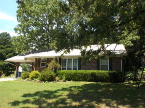 Cute home in town with hardwood floors, large deck and almost a 1/2 acre tree-shaded lot. There could be a 3rd bdrm from the room that is being used as a living room that includes a closet and half bath. Carport attic is well insulated and has some storage space. All appliances convey. All numbers approximate.