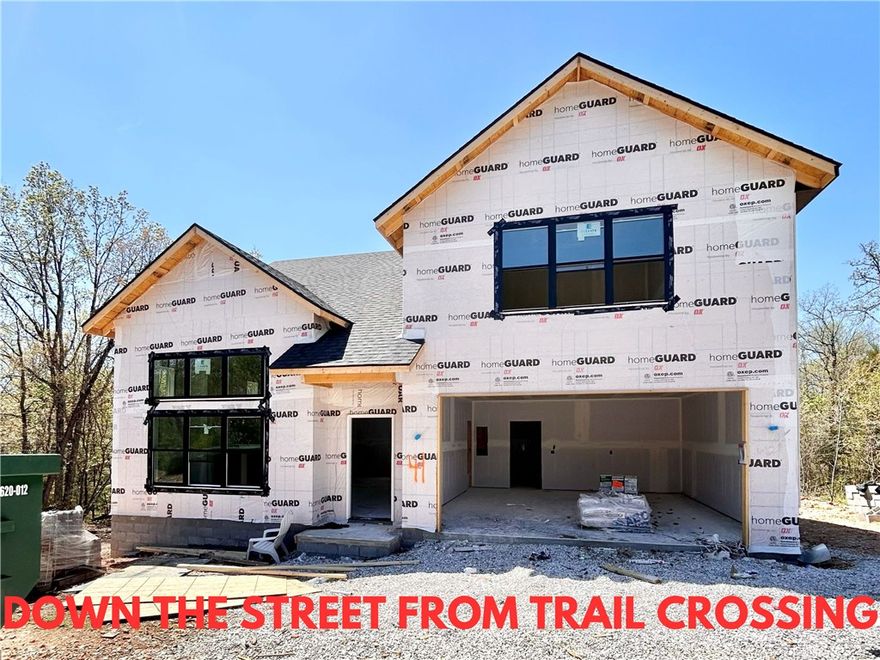 New construction home on a large .31-acre wooded lot! Just down the street from the Taylor Homestead Trail Crossing! Step into a bright and airy interior featuring tall ceilings and a striking 2-story fireplace. The kitchen boasts custom cabinets, a gas range, and 3 cm quartz countertops. The primary bath features a luxurious soaking tub and a walk-in tile shower. Enjoy abundant natural light throughout, and entertain on the spacious deck overlooking the serene landscape. Custom finishes throughout. Bentonville schools! As an added bonus, receive $3,500 towards buyer's closing costs when working with the builder’s preferred local lender! Schedule your showing today!