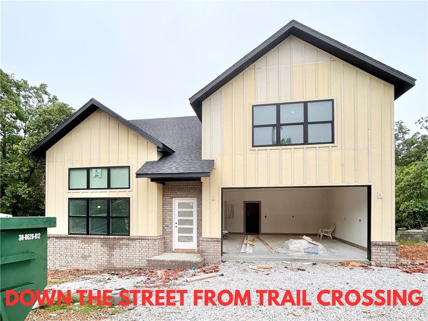 New construction home on a large .31-acre wooded lot! Just down the street from the Taylor Homestead Trail Crossing! Step into a bright and airy interior featuring tall ceilings and a striking 2-story fireplace. The kitchen boasts custom cabinets, a gas range, and 3 cm quartz countertops. The primary bath features a luxurious soaking tub and a walk-in tile shower. Enjoy abundant natural light throughout, and entertain on the spacious deck overlooking the serene landscape. Custom finishes throughout. Bentonville schools! As an added bonus, receive $5,000 towards buyer's closing costs when working with the builder’s preferred local lender! Schedule your showing today!