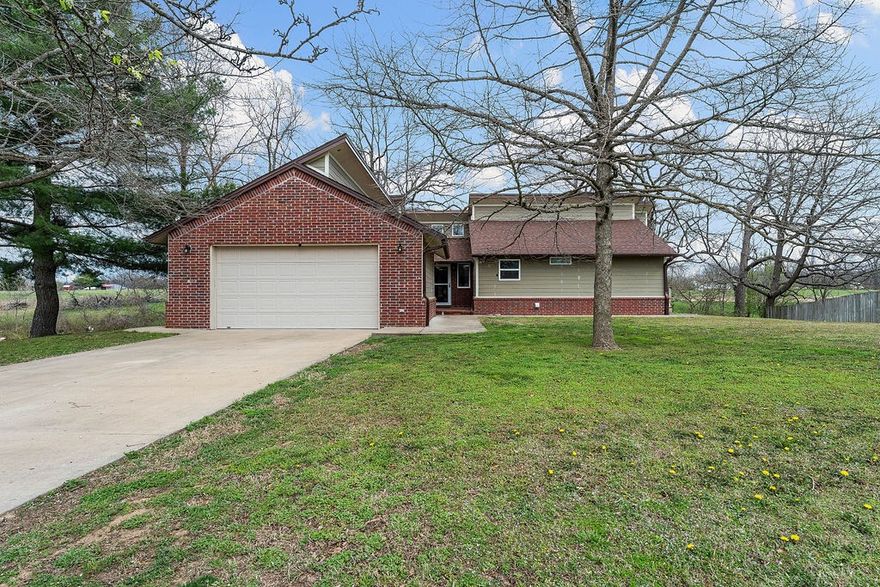 What a great property! This beautiful home sits on 1.46 acres and is conveniently located close to Downtown Rogers or Pea Ridge! The home has a walk out basement and tons of great space! Features include an open concept main living area and kitchen! The kitchen has massive amounts of cabinets and countertop space, double ovens, trash compactor, island, and more! In the living room you will enjoy cozy fires in the woodturning fireplace! Hurry because this one will go quickly!  Subject to lots split approval. New lot line will be in the ravine behind the house
