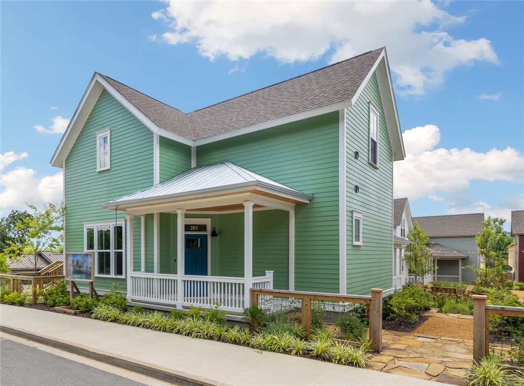 FIRST MONTH FREE. Welcome to the 11th Street Cottages, a thoughtfully designed new community centered around lush private gardens, just two blocks east of Walker Park and the Razorback Greenway. You're so close to Fayetteville’s vibrant downtown square and UofA. This spacious floor plan offers a bright, open-concept layout with a large living area and a modern kitchen featuring ample prep space, high-end cabinetry, and a central island with bar seating for casual meals or entertaining. With primary suites and laundry connections on both levels, the flexible design supports a variety of living arrangements. Enjoy large bedrooms, walk-in closets, and spa-like bathrooms with quality finishes. A versatile upstairs bonus room is perfect for a home office, nursery, or lounge. Built for comfort and sustainability, the home includes ENERGY STAR high-performance systems for low utility costs, healthy indoor air, and year-round efficiency.
