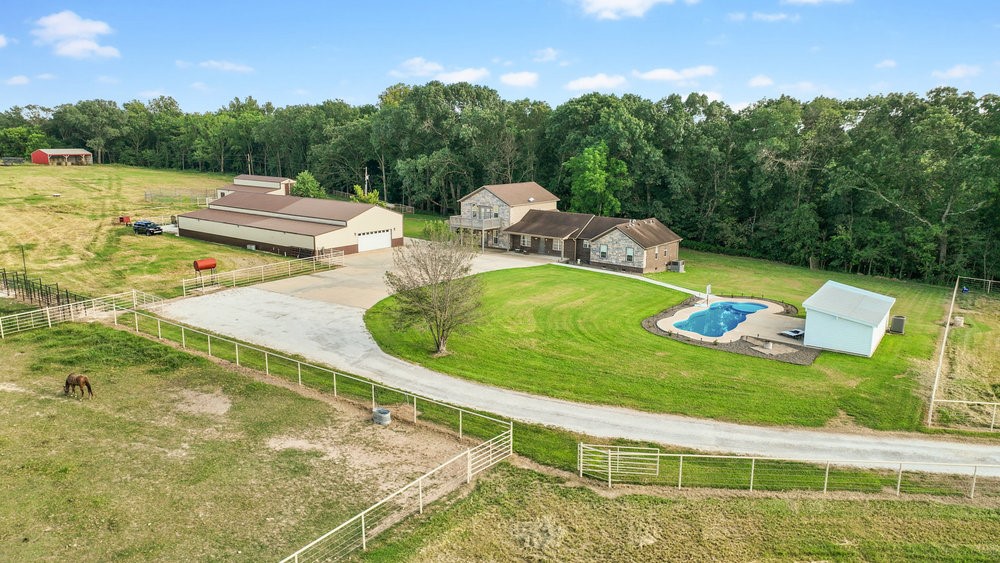 This one checks all the boxes—30 acres, a heated saltwater pool, custom horse barn, and a home full of thoughtful upgrades inside and out. Whether you're after a full ranch setup or just want the space and peace to stretch out, this estate brings flexibility and function in a big way. The home includes 3 new DUAL FUEL HVAC systems, fresh paint, updated kitchen with granite and new appliances, and a primary suite with walk-in shower and soaker tub. Bonus spaces upstairs and down have been reimagined for work, guests, or entertaining. Outside, the custom-built 36x50 horse barn includes water access, tack and feed rooms, and small runs. You’ll also find a newly expanded 3500 sf heated and cooled shop with gym and bath, a hay barn, upgraded fencing, new watering systems throughout, and a cleaned-up field ready for livestock or play. The pool area has its own upgrades too, including a new equipment room, walkway, and hot tub setup. Plenty of room to live, work, and enjoy.