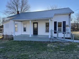 Clean 4 bedroom home sitting on 2 acres more or less with detached storage/workshop building. Has newer metal roof and HVAC was installed in 2013. Big covered front porch. Only 5 minutes from city limits located on pavement. Upstairs is finished square footage but is not on central heating and air.