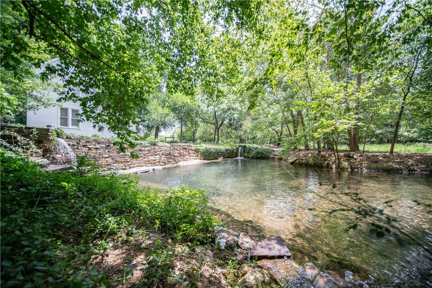 Welcome to Spring Farm. Located on the Arkansas Heritage Trail in historic Springtown, this 19th century farmhouse rests on 21 (+/-) acres and is the home of “Big Spring,” the largest privately owned spring in Benton County and the headwaters of Flint Creek. Acreage includes 2 city lots and control of Flint Creek through the main city of Springtown. Average flow of around 5 million gal. per day. Built in 1875, with kitchen and dining added in 1924. The home features original heart pine floors, 5 bedrooms, 2 baths. The house draws its water directly from the spring and has a whole house water purification system. Property also features organic gardens, park-like shade trees, and landscaping. Flexible zoning for residential or commercial, Highway frontage on Hwy 12 between Bentonville and Siloam Springs, and 10 min from XNA this property can serve for anything from a wedding venue, B&B, or farm-to-table restaurant. Acreage to be verified by buyer. Cross Reference MLS #1211369 and #1215427. Property sold AS IS.