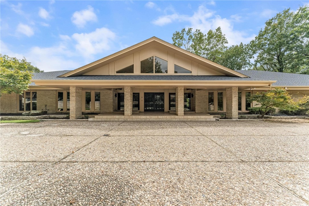 Iconic Mid-Century Estate with Lake Fayetteville ViewsāA Springdale Legacy. Step into a piece of Springdale history with this architecturally significant home, originally built in 1950 by renowned local builder and city icon Sandy Boone for Joe and Gretchen Steele. Perched on 4.41 acres with unparalleled view of Lake Fayetteville, this one-of-a-kind property offers nearly 7,000 sq ft of beautifully designed living space, including a 2,500 sq ft separate gym. Constructed with rare fossilized limestone block, the home's timeless mid-century design is enhanced by recent, high-end updates. The primary suite, completely remodeled in 2025, features dual spa-like bathrooms, refined finishes, and a serene, private retreat with modern elegance. Seven expansive sliding glass doors line the back of the home, seamlessly blending indoor and outdoor living while providing panoramic views of the newly resurfaced pool, cabana with outdoor kitchen, and the surrounding natural landscapeāa true gem in Springdaleās real estate market.
