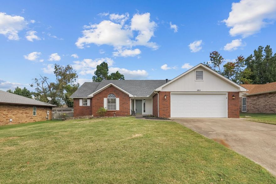 Welcome to 1811 North 22nd Street in Rogers, ideally located within walking distance of the Rogers Aquatic Center and just 10 minutes from the Walmart AMP. This beautifully remodeled 3-bedroom, 2-bathroom home features thoughtful updates throughout, including an architectural shingle roof replaced 2 years ago and new double pane vinyl windows coming soon. The updated kitchen boasts 3cm granite countertops, electric cooktop, undermount sink, new lighting and plumbing packages, and custom cabinets with pull-out drawer storage in the pantry. Wood-look tile and carpet flow throughout, while both bathrooms have been renovated with walk-in showers featuring seamless glass and modern vanities. The spacious primary bedroom includes a walk-in closet and relaxing jacuzzi tub. Additional features include a two-car garage with workshop area, HVAC from 2019, mud sink in the laundry, formal and informal dining areas, and a covered back patio. The property is fully fenced with privacy fencing in back and chain link on the sides.