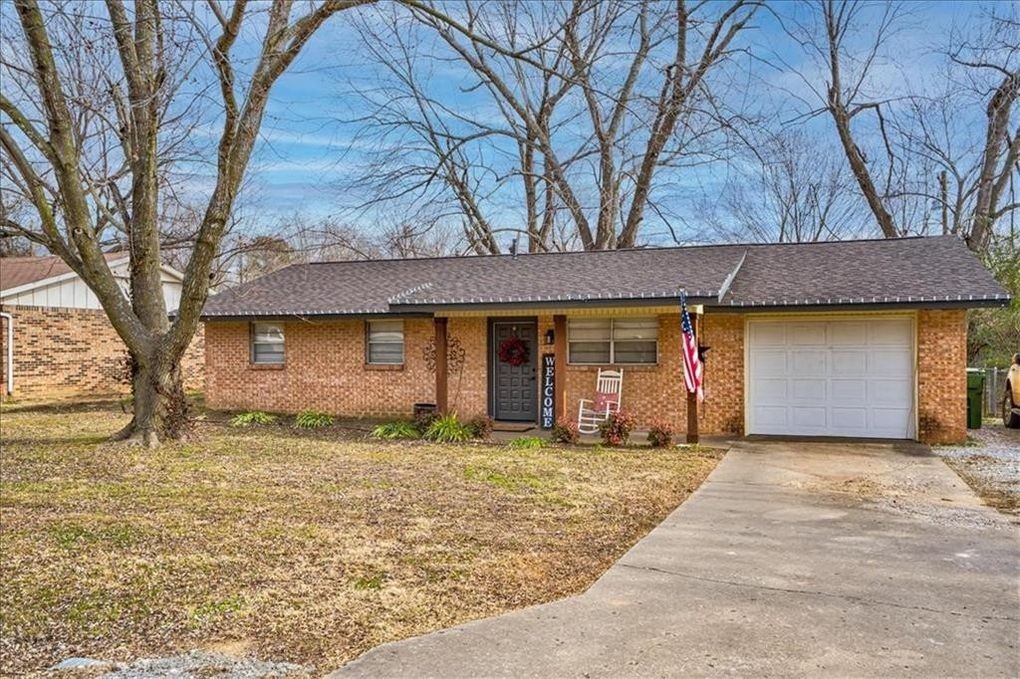 Charming brick home in Rogers! Wood floors in main living space. Updated kitchen and spacious backyard!