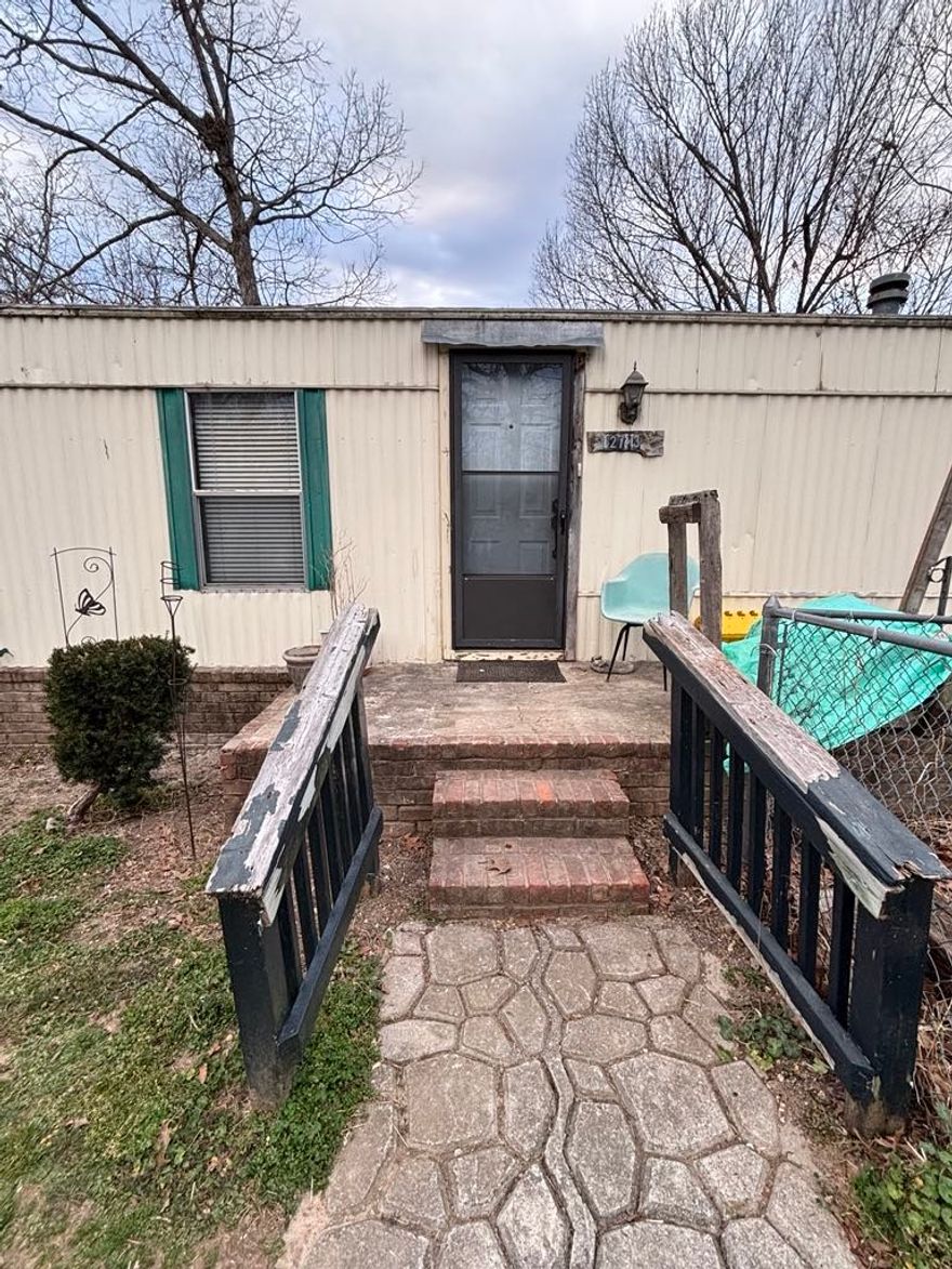 Nice, Clean mobile, with permanent brick skirting.  All electric with wood burning stove & security system.   3 bedrooms 2 bath split plan with eat in kitchen.  All solid surface flooring - no carpet! Being Sold AS Is! * Be very careful in the back yard because it is a steep slope.