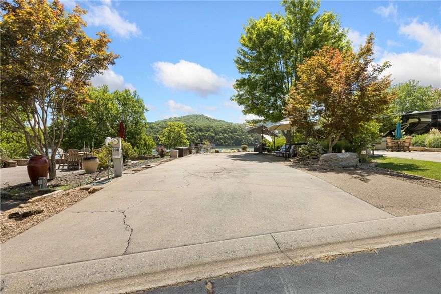 Located in Oak Grove, Arkansas, within the Ozarks Luxury RV Resort just south of Branson, this beautifully landscaped front-row lot features its own water feature and offers stunning panoramic views of Table Rock Lake. This site fits motorhomes up to 45 feet, with ample patio space and room for a tow car plus a golf cart without compromising living space. —perfect for relaxing or renting out. The resort features paved roads and top-tier amenities: two pools, tennis and pickleball courts, a fitness center, large off-leash dog park, and a courtesy dock with lake access. Private security adds peace of mind. Just 20 minutes from Big Cedar Lodge and 30 from Branson, you’ll enjoy easy access to Johnny Morris attractions like Top of the Rock, Dogwood Canyon, Thunder Ridge Nature Arena, and Silver Dollar City. With world-class fishing and great golf nearby, there's something for everyone. Lot 298 is ideal for personal use or as a proven income-producing rental. Keep this piece of heaven to yourself—or share it with others.