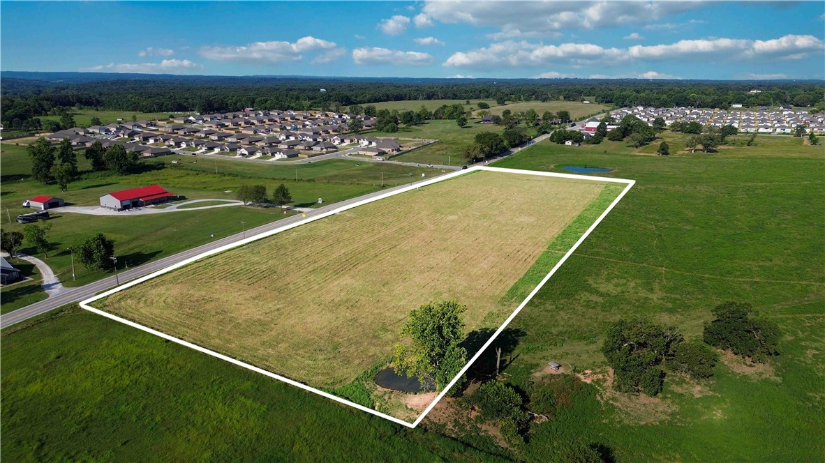 Prime Location Near XNA, Offering approximately 6 acres of pasture land, currently zoned Agriculture with the potential to be rezoned for commercial use. This property boasts major Highway 264 frontage, providing excellent visibility and accessibility. A pond sits on the right side of the property (facing from the highway) and is included in the acreage. Conveniently located with easy access to Northwest Arkansas Regional Airport (XNA), and with the upcoming Highway 612 bypass, this location will soon offer even greater connectivity to the rest of Northwest Arkansas. Ideal for future development or investment in one of the fastest-growing regions in Arkansas.