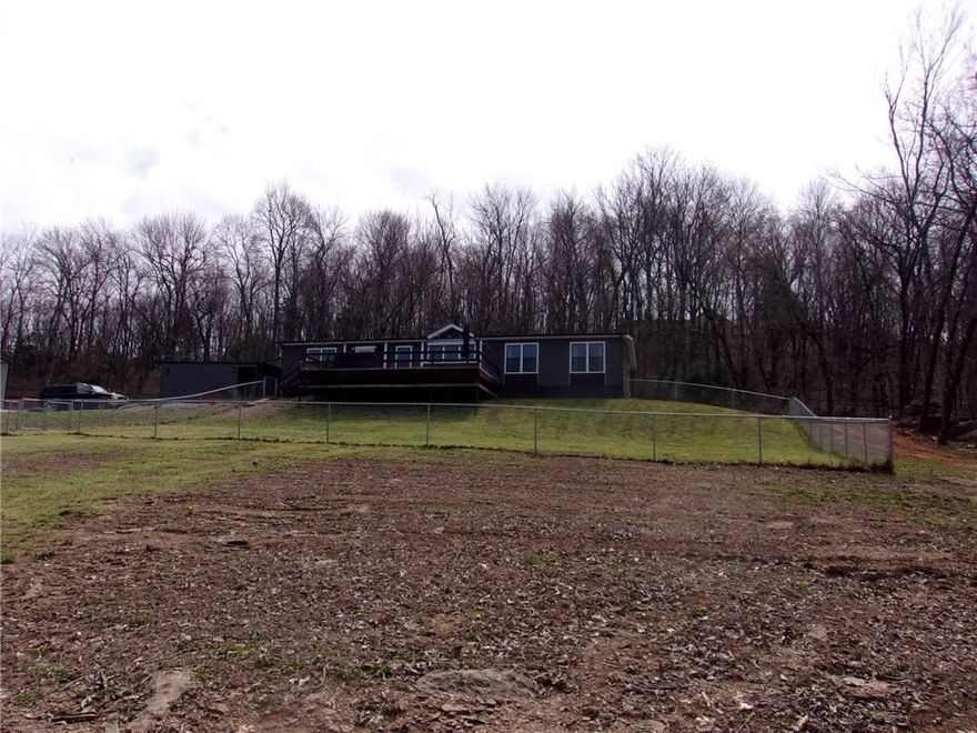 2019 Cavalier Home on 3 beautiful acres This 4 bedroom 2 bath home on permanent foundation. This home is like new. The refrigerator and washer and dryer, large safe and outdoor patio furniture  will convey. Kitchen has every thing you need to be your own chef.  Wood counter top. With eat in kitchen and place for bar stools for extra seating. Detached carport is 22x31 and RV carport 45x25 with 30 amp for 220 with 110 receptacle.  Also has storm seller 6x10. chain link fence around front portion of yard. Also chicken pen for your chickens.