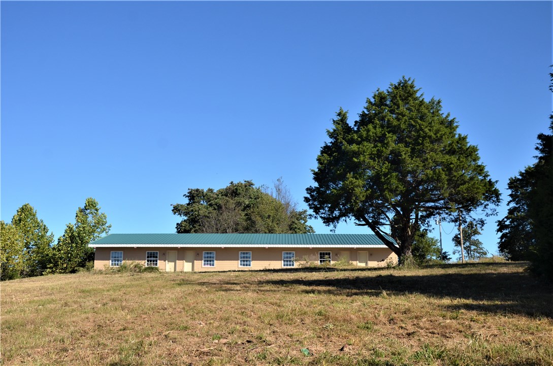 Price just reduced--well below appraisal value!
Perfect for vacation rentals! Beaver Lake area, just 4.4 miles from Lost Bridge Marina. 6 units with plenty of room to expand. Each unit has 2 bedrooms, a kitchenette, and 1 bath and could sleep 4+. Building also includes an office/studio with a bathroom and a storage room with washer/dryer hookups. Possible uses: AirBNB, VRBO, extended stay lodging, fishing lodge, RV Campground, and much more! All units include existing furnishing. Back half of land is vacant and prime for expansion/development. Structure is steel framed with metal studs for interior framing and roof system is 14 gage steel purlins with 26 guage R panel roofing.