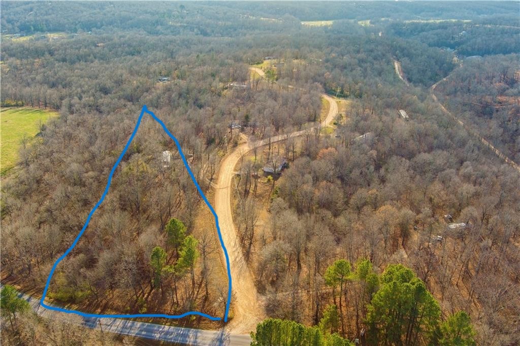 Beautiful 5 Acres, secluded, yet conveniently located. This parcel has 400 ft of Harmon Rd frontage. About 1 acre is wooded and the rest is clear and ready to build on. The property has a septic, a well ran well system, and rural water taps that have been paid for. Your dream home is calling.