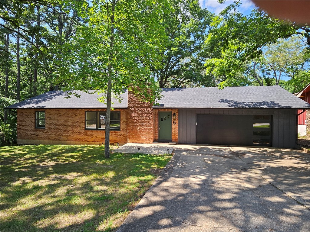 This charming home seamlessly blends comfort and practicality, with major updates already completed—including a new roof, water heater, and cooktop. While some finishing touches remain, they provide an opportunity to customize the space to match your style and preferences.
The upper-level hardwood floors have been beautifully refinished, while the kitchen and dining area now feature newly installed pine flooring, adding warmth and character to the space.
The garage and carport have been fully rebuilt, resulting in a spacious two-car garage with insulated enclosed walls for added protection.
With three bedrooms and two and a half bathrooms, this home offers generous space for both family living or entertaining. The walk-out basement adds versatility, leading to a fenced area and a picturesque wooded .60 acre lot.
The property’s prime location is one mile from downtown Eureka Springs, close to shopping centers, and scenic trails makes it a perfect choice for families or those who value easy access to amenities.