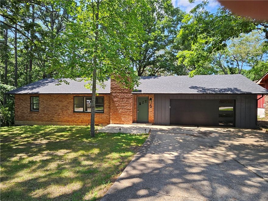 This charming home seamlessly blends comfort and practicality, with major updates already completed—including a new roof, water heater, and cooktop. While some finishing touches remain, they provide an opportunity to customize the space to match your style and preferences. 
The upper-level hardwood floors have been beautifully refinished, while the kitchen and dining area now feature newly installed pine flooring, adding warmth and character to the space.
The garage and carport have been fully rebuilt, resulting in a spacious two-car garage with insulated enclosed walls for added protection.
With three bedrooms and two and a half bathrooms, this home offers generous space for both family living or entertaining. The walk-out basement adds versatility, leading to a fenced area and a picturesque wooded .60 acre lot.
The property’s prime location is one mile from downtown Eureka Springs, close to shopping centers, and scenic trails makes it a perfect choice for families or those who value easy access to amenities.