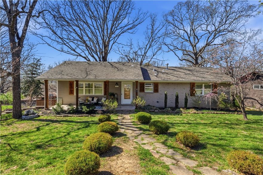 Beautifully maintained home in a prime Fayetteville location near Root Elementary and just minutes to the University of Arkansas, Dickson Street, and the Downtown Square. Interior freshly painted in 2025 with a thoughtful remodel completed in 2014, blending charm with modern comfort. Warm, real hardwood floors flow throughout the main level, creating inviting and functional living spaces. The home features 3 full bathrooms, offering flexibility for families, guests, or growing households. The spacious primary suite provides a peaceful retreat with excellent storage. Large windows with classic wood shutters bring in natural light while adding timeless character. Enjoy outdoor living on the expansive multi-level deck system, perfect for relaxing or entertaining, surrounded by mature trees and refreshed landscaping completed this year. A welcoming covered front porch and established neighborhood setting make this home ideal for comfortable Fayetteville living.