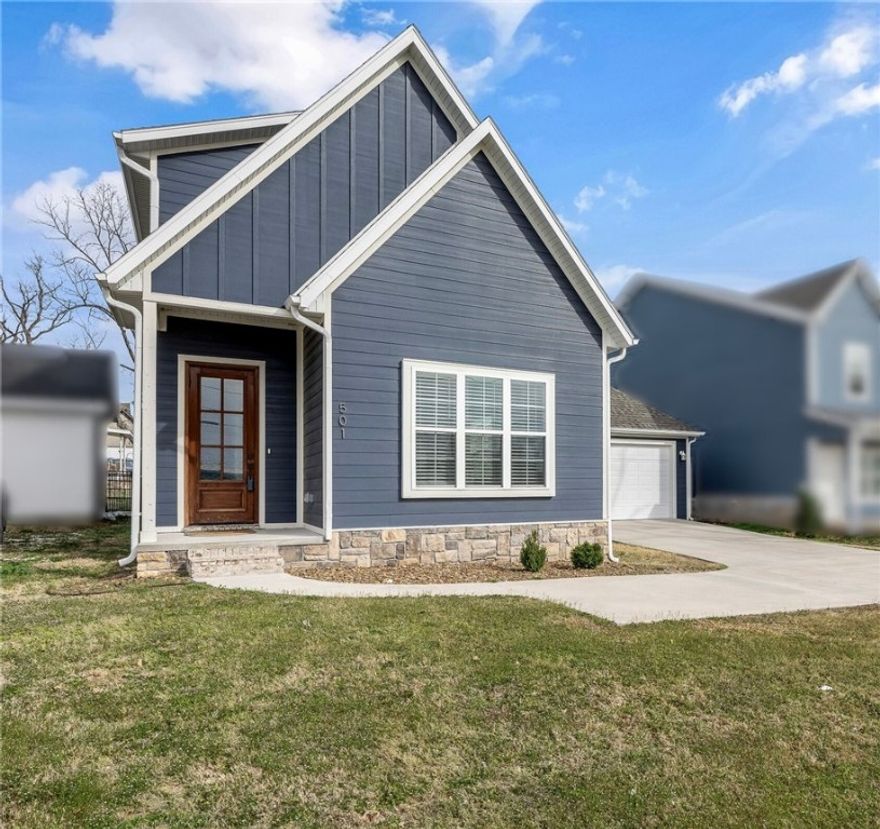 This stunning home in downtown Rogers offers an unbeatable location near entertainment, schools, fine dining, and scenic trails. Inside, you'll find a spacious living room filled with natural light and an open floor plan. The modern kitchen features sleek modern cabinets, quartz countertops, stainless steel appliances, a large island, pantry, and eat-in area. The primary suite on the main level boasts LVP flooring, a luxurious ensuite with double sinks, a walk-in tile shower, and a large walk-in closet. Upstairs, three spacious bedrooms with LVP flooring and walk-in closets surround a cozy landing area. A detached garage provides ample storage, while the patio is perfect for entertaining! Great investment opportunity, with its desirable location, modern features making it an attractive option for both personal enjoyment and financial gain.