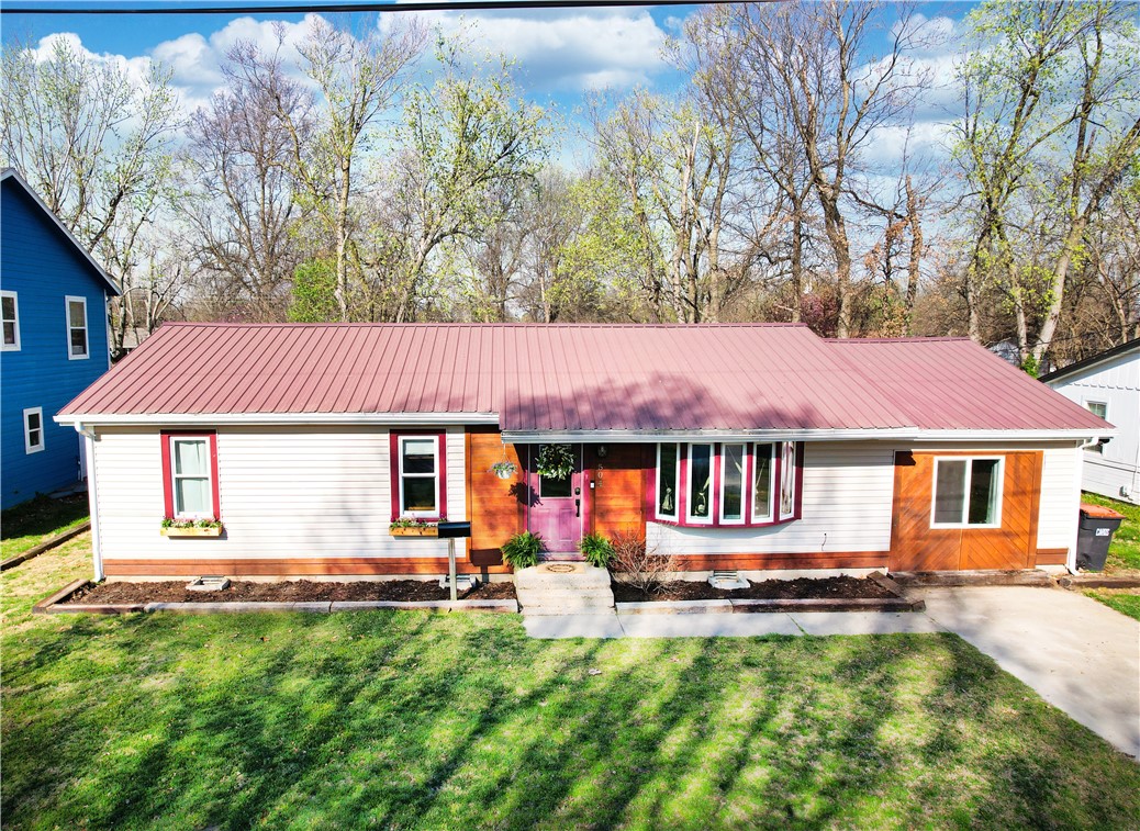 Ideally situated, this beautifully renovated 4-bed, 2-bath home is on a peaceful, family-friendly dead-end street. Tons of updates for modern comfort with new electrical throughout, ensuring peace of mind for years to come. Step inside to open-concept kitchen/living room, including farmhouse sink, shiplap backsplash, quartz countertops, stainless steel appliances, & custom-built cabinet/pantry with a butcher block buildout. Framed-in electric fireplace creates warmth, style, & function. Outside, discover a 225 sq. ft. metal shop with 2 lofts, an electric vehicle charging station, & an oversized deck surrounded by a wooden privacy fence perfect for entertaining or relaxing. Just steps from Westwood Elementary (0.3 miles), Murphy Park (0.7 miles), Springdale High School (0.8 miles), & a short bike ride to downtown Springdale. Close to hospitals, shopping, dining, and I-49--prime location and move-in ready.