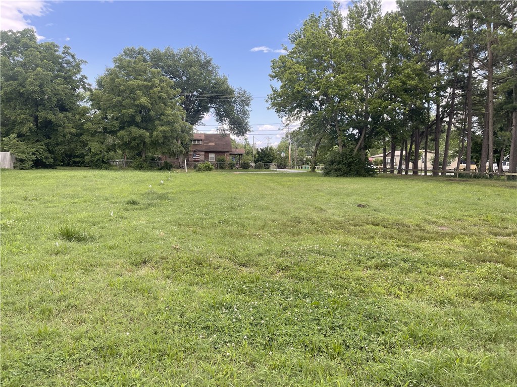 Serious development potential on large .73 acre lot. Likely rezoning to commercial or multifamily. Single sewer tap already on site. Red iron framed 1500 SqFt workshop with rolling door conveys.