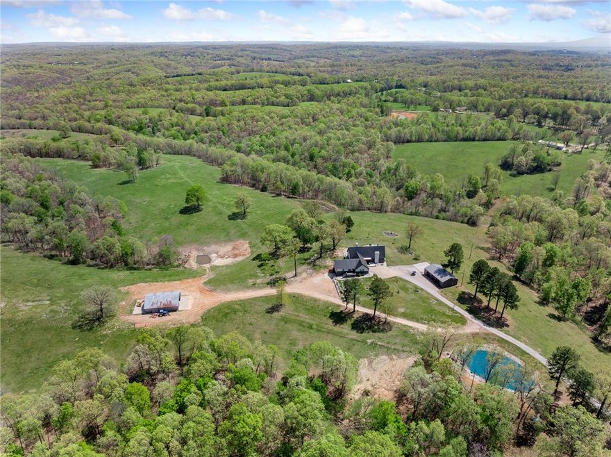 This spacious 5-bed, 3-bath home blends comfort, flexibility, and outdoor living. The beautifully updatedkitchen is perfect for gatherings, while the versatile layout includes a large in-law suite or game room—great for multi-generational living or entertaining. Outside, explore established side-by-side trails orunwind in the private hot tub under the stars. A 3-car detached garage and second barn with electric andwater provide space for hobbies, livestock, or storage. Multiple RV hookups make hosting easy or supportyour travel lifestyle. A whole-home generator adds peace of mind year-round. Whether you're looking forspace to grow, work, or relax, this property offers it all in a peaceful, scenic setting. From cozy nights in toadventurous weekends out, this is country living with modern comfort.