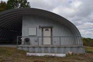 Great escape with 20.6 acres m/l located close to Bull Shoal Lake. 50 x 40 Quonset Hut with living quarters, water, electric and septic. Excellent views with perfect home sites. Need toilet hooked up and plumbed too. Foam insolated.