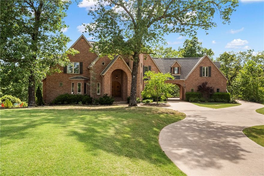 Experience The Estates of Lakeway, a resort style gated community located just ten minutes from Downtown Rogers and less than 30 mins to Walmart Home Office! This stunning home comes with a private 10 X 25 foot boat slip at the community dock just a short walk away. The circle driveway and portico passthrough offer a multitude of parking for entertaining. Up the side stairs above the garage is a fully equipped private one bedroom apartment. Could be used for rental income or perfect for the college student. This 3 level home sits on 2 acres for ultimate privacy with gorgeous mature trees. 2 large covered spaces out back for you to sit and enjoy the nature. This Beaver Lake community is esteemed as THE premier community to be in! Multiple living areas, wide open floor plan designed for hosting, heated/cooled additional basement garage/workshop that could be completely finished out or is great for storage and yard equipment.  Don't miss this one!