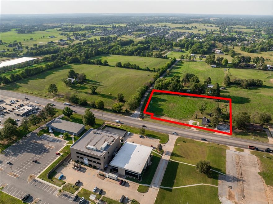 Zoned C2 – Prime corner on Hwy 412 West, directly across from Pam Trucking. Offers side street access for an alternate route to the Barrington stoplight or quick connection to Hwy 112. All city utilities are available, and the location boasts excellent visibility. The lot includes 381 feet of Hwy frontage and 289 feet along Tessaro Street. A great investment opportunity, the property currently has an 1890s-era home and a small retail building, but the true value lies in the land. Traffic count of approximately 39,000 per day.