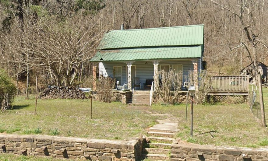 Public Auction held on-site Friday, May 29th at 10:00 AM. Live and online bidding available. 4-bedroom, 1-bath home built in 1940 situated on approximately 4 acres. Property features include original hardwood floors, natural stone accents, metal roof, wood-burning stove, and a covered front porch looking out at the mountains. Home includes a cellar with exterior access (needs improvement) and an underground storm shelter. Additional improvements include a detached building approximately 300 SF (+/-) with electric. Former chicken house structure remains, offering salvageable wood and metal materials. Land consists of a mix of open areas and wooded acreage with mature trees and abundant wildlife. Located just over 1 mile from St. Paul, approximately 20 miles to Elkins and Huntsville, and about 30 miles to Fayetteville and White Rock. Reserve auction. Property sold As-Is. Buyers are encouraged to view and/or inspect prior to auction. See website for full terms and conditions.