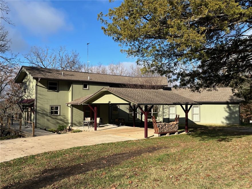 Beautiful waterfront home on Beaver Lake w/ 382’ of shoreline. 250’ feet to water’s edge.
Optional 10’x26’ boat slip for additional monies (possible owner financing). 1600 SF red iron
building, insulated, wood heat, electric doors, 100-amp service. Home was completely
reconfigured/remodeled in 2017, w/ 1000+ SF added. Every room has a view of Beaver Lake
(excluding the upstairs bathroom). Custom stairs, kitchen bar, and forced air wood burning
fireplace. Large 330 SF primary bedroom and 264 SF primary bath w/ jetted tub, custom 22 SF
shower w/ rain head and 8 jets, 2 vanities, 2 walk-in closets, and separate toilet room. Luxury
vinyl and tile throughout. All windows are Anderson double hung tilt-in. Kitchen has
LG appliance suite, soft close drawers/cabinets. Large 63 SF laundry room. Office could be
converted to third bedroom. Two HVAC units. New water heater/water softener. 225 SF front
porch, 400 SF carport, 825 SF deck. 210 SF walk-out basement is a bonus room
remodeled 2025.7 min drive to dock.